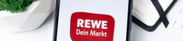 New York, USA - 1 August 2024: REWE Logo on Phone Screen, Company Icon on Display Von Postmodern Studio
